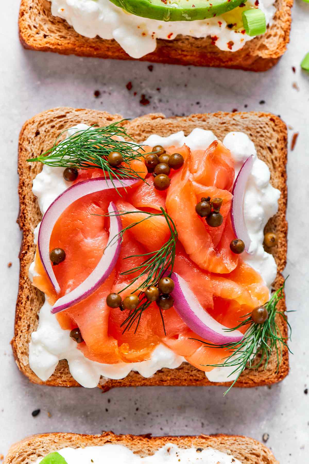 cottage cheese toast with smoked salmon, capers, dill, and red onion.