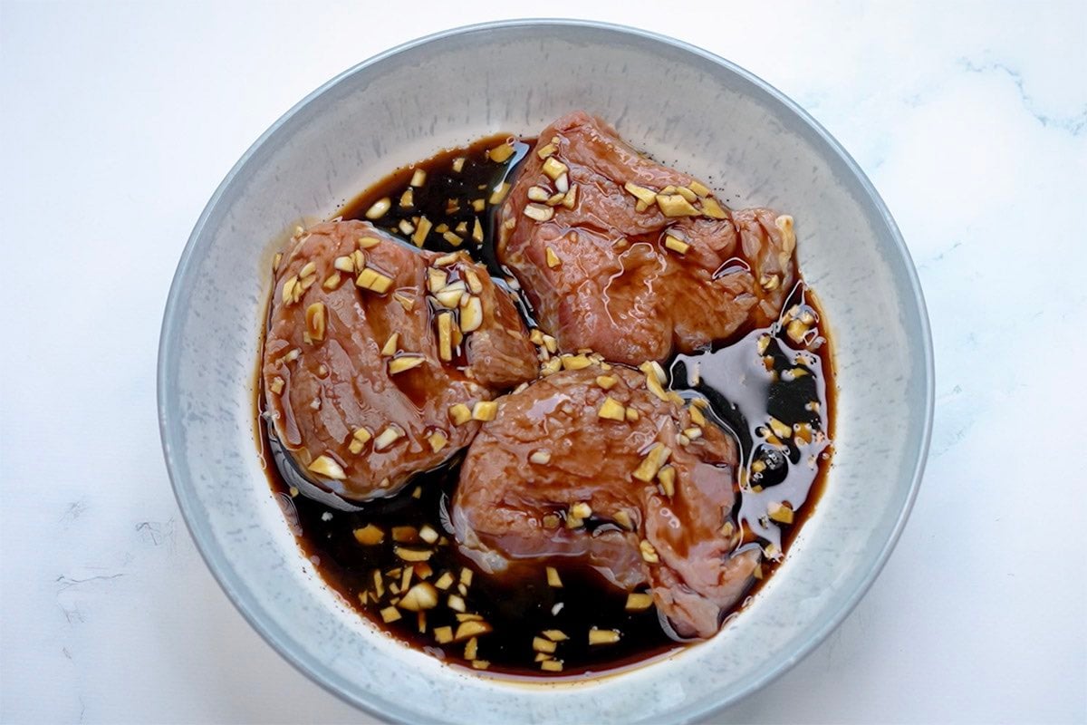 steak soaking in marinade.