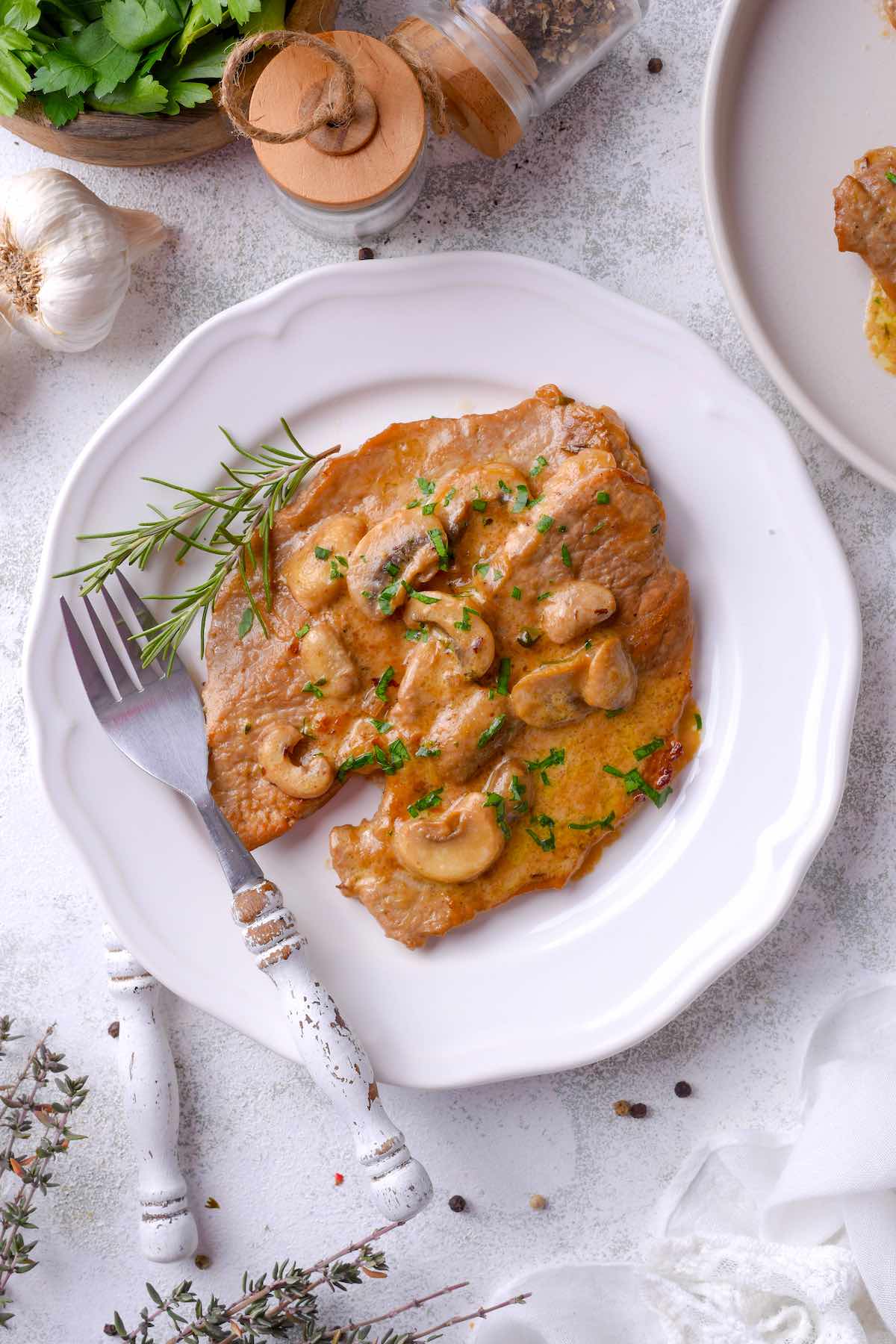 veal marsala on a white plate.