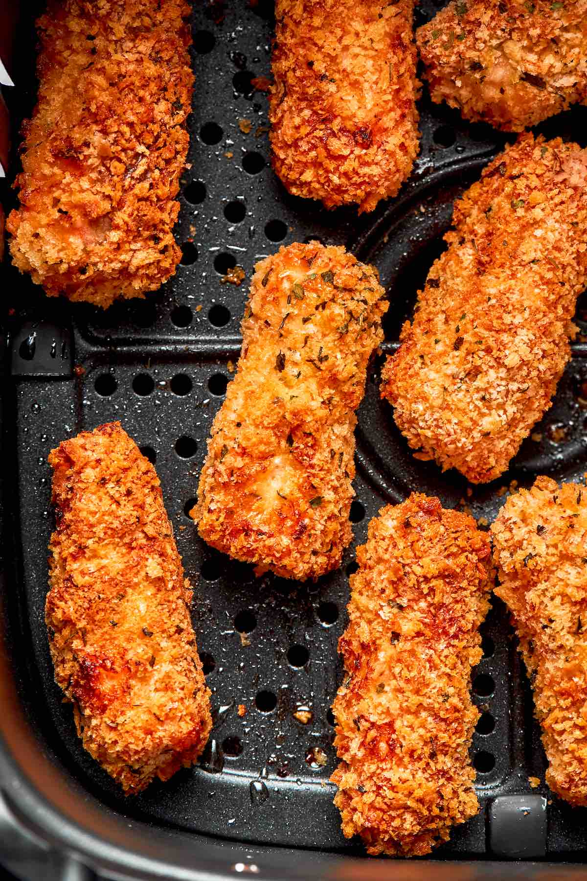 crispy air fryer fish sticks in the air fryer basket.