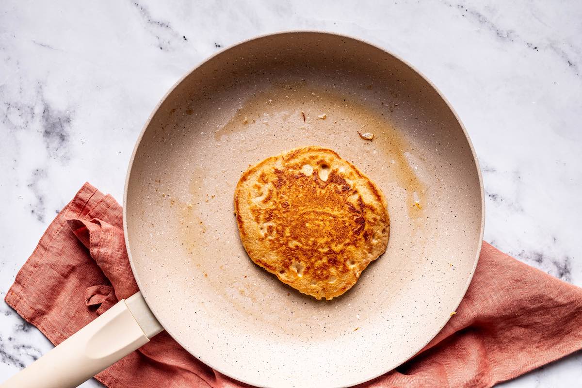 oat pancakes cooking in a skillet.