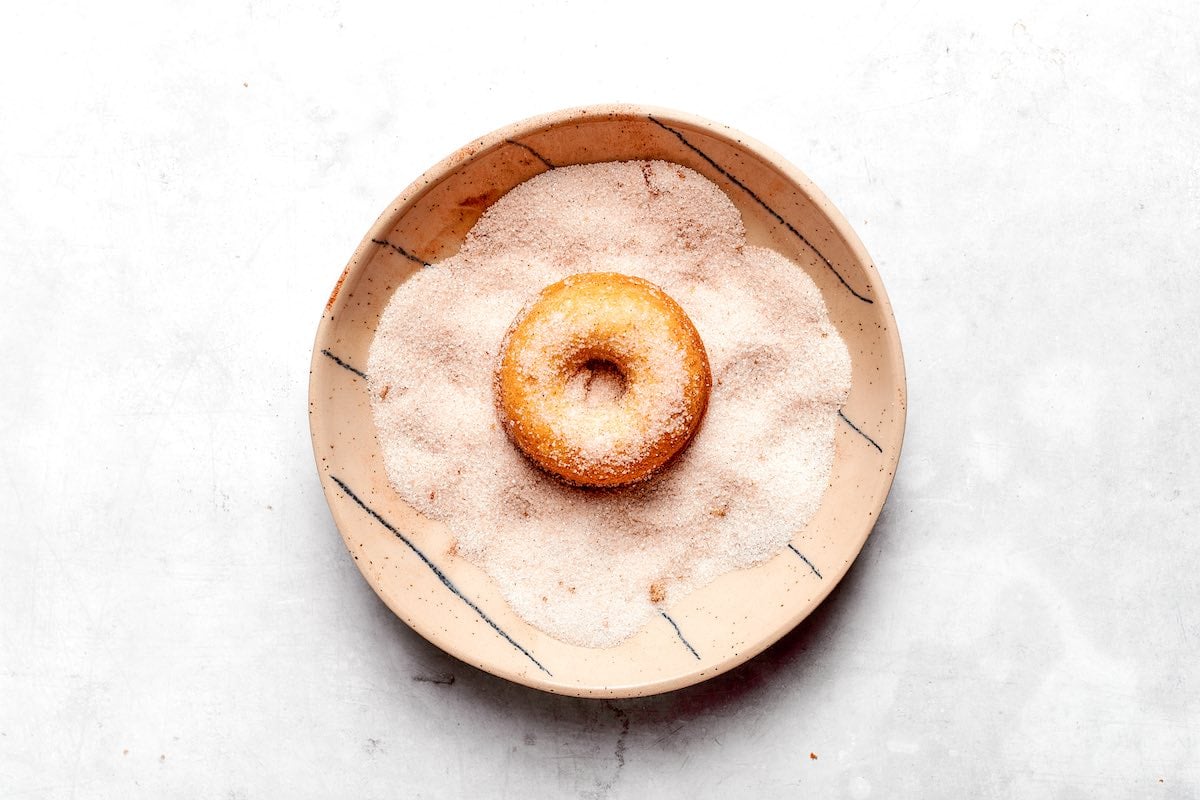dipping donuts in cinnamon sugar.
