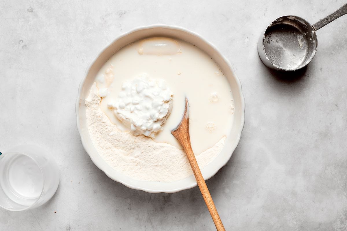 cottage cheese, milk, and flour in a bowl.