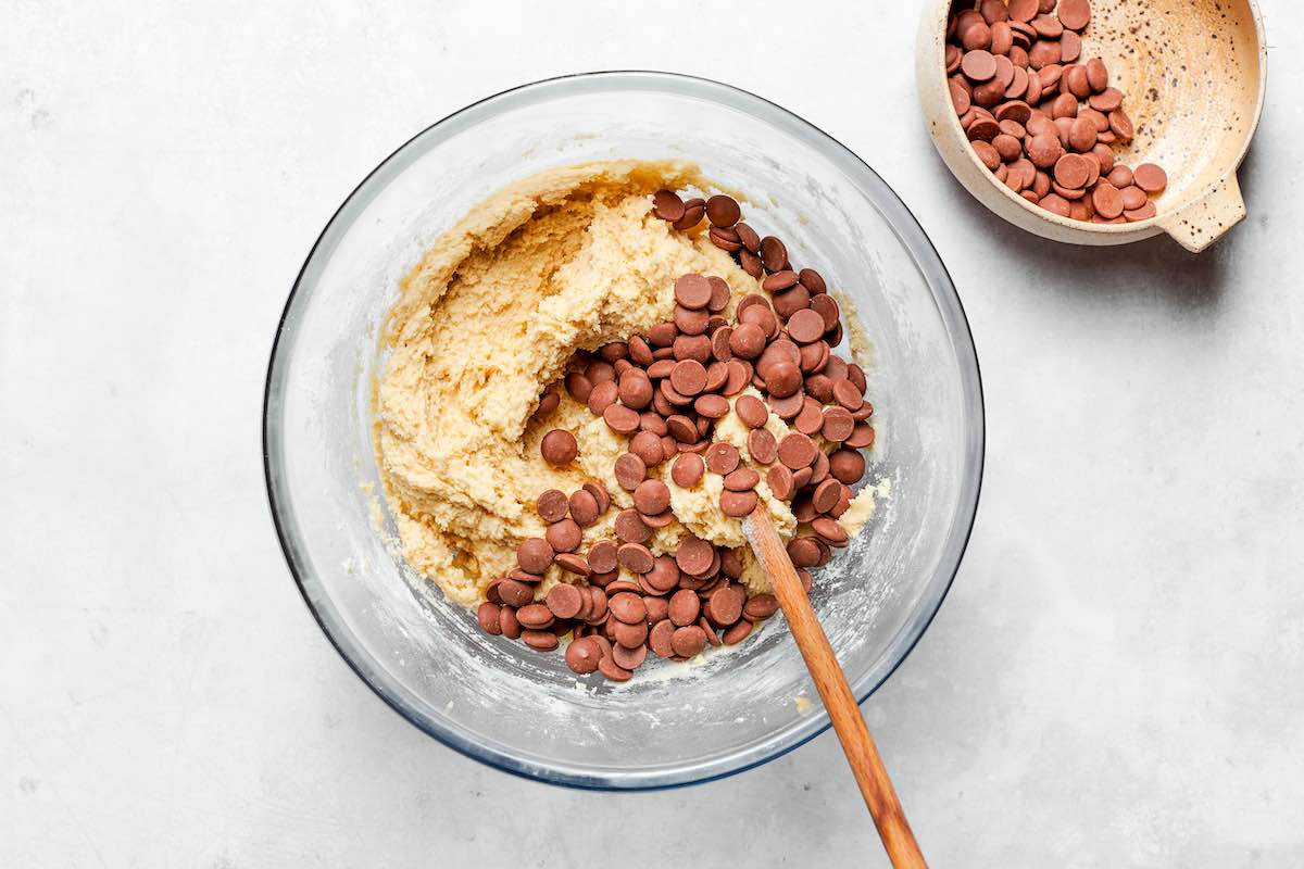 folding in chocolate chips into cookie dough.