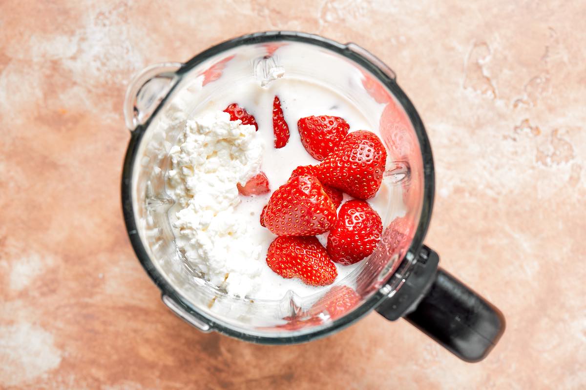 cottage cheese, milk, strawberries, banana, and maple syrup in a blender.