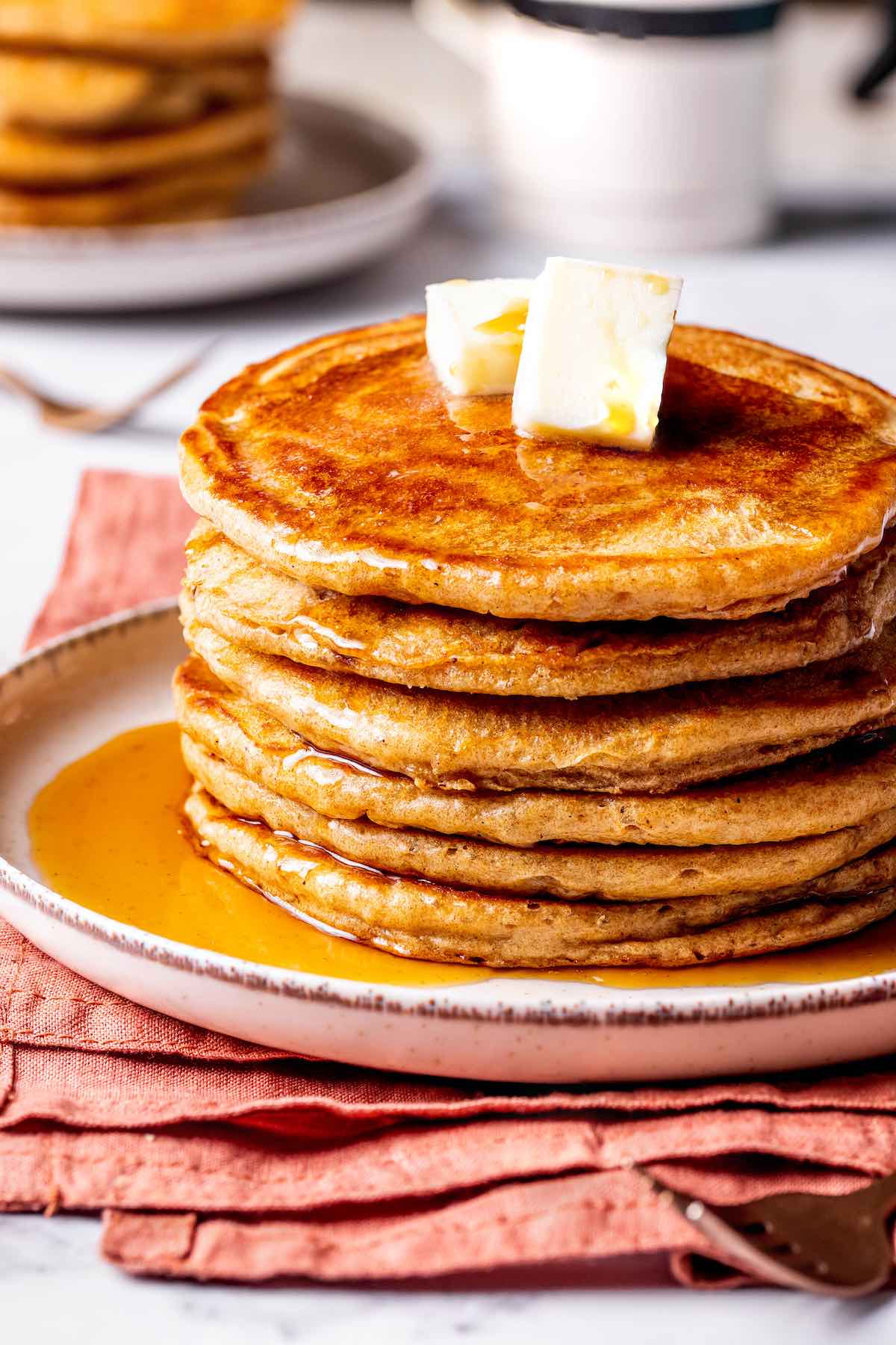 stack of oat milk pancakes with butter on top.