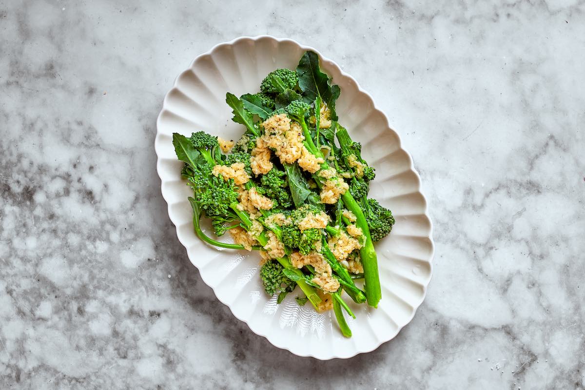 raw broccolini with olive oil and garlic on top.