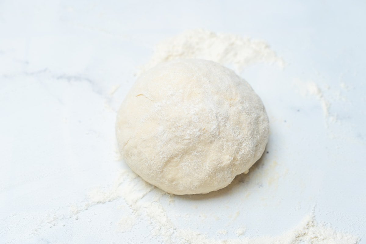 ball of dough on floured surface.