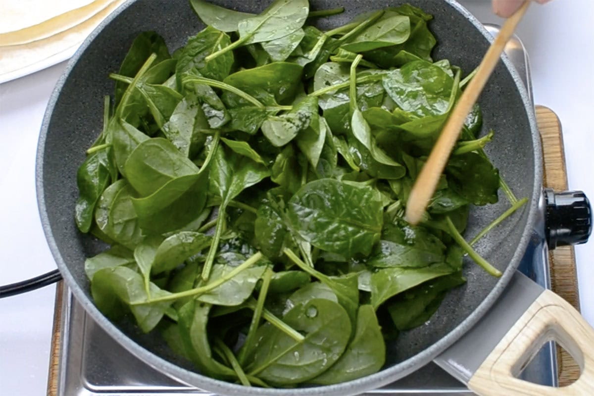 spinach wilting in a skillet.