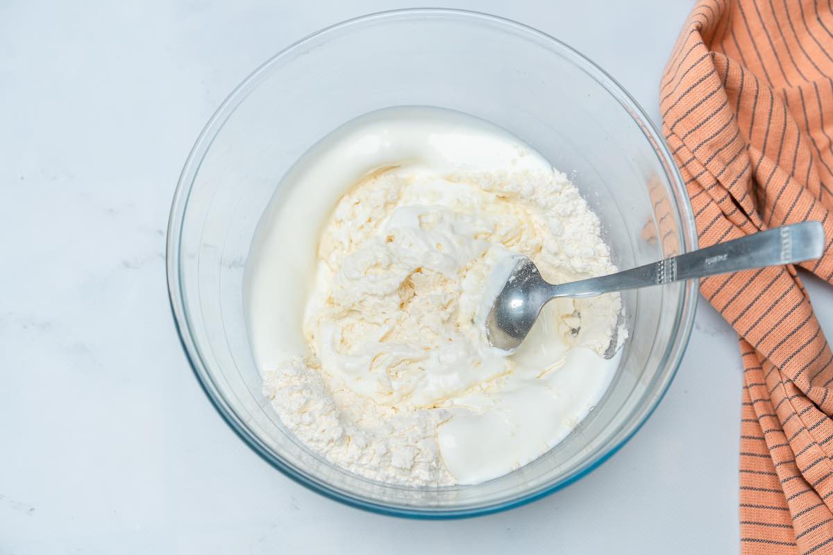 Greek yogurt and flour in a mixing bowl.