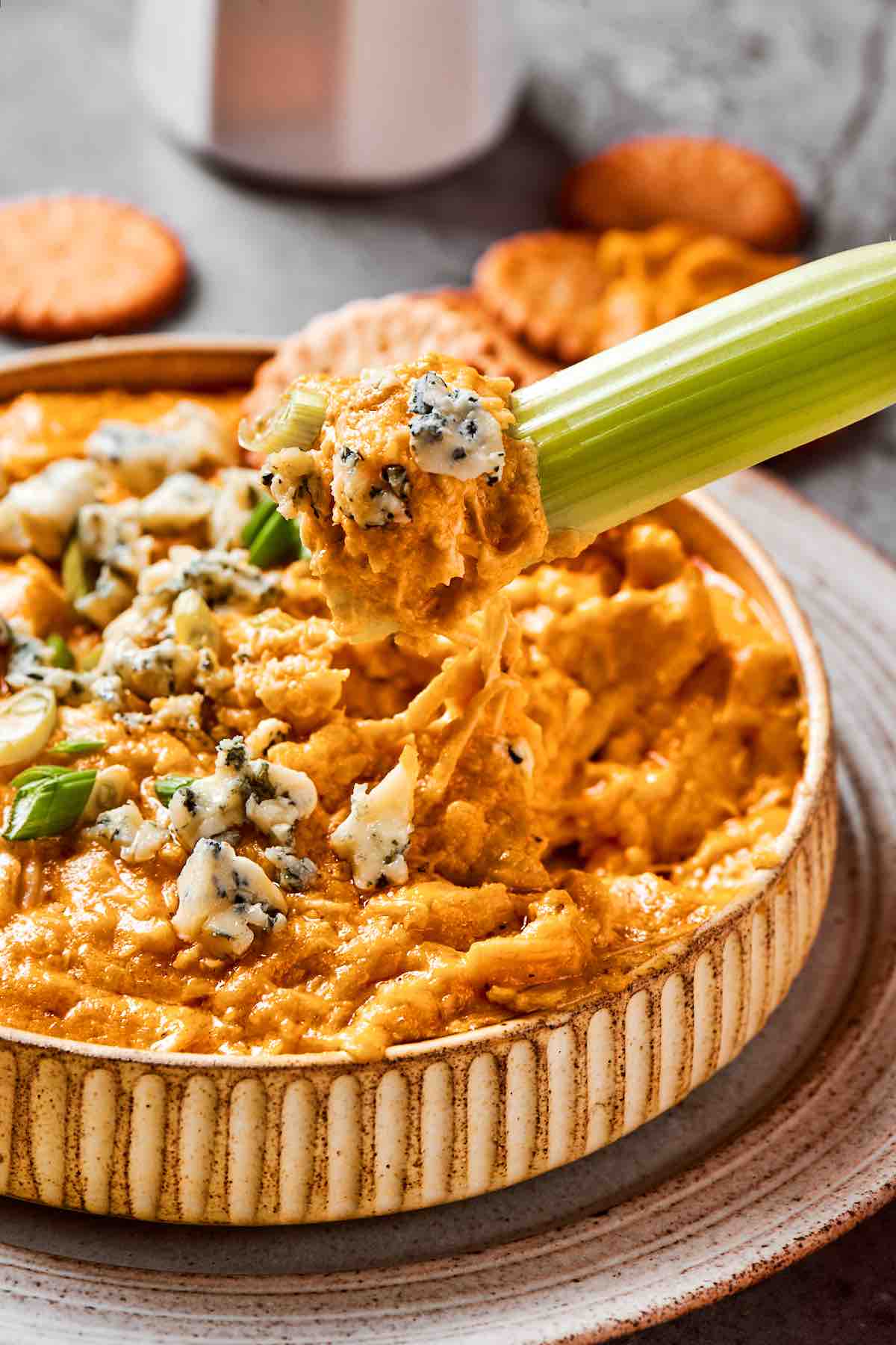 buffalo chicken dip in a bowl with celery for dipping.