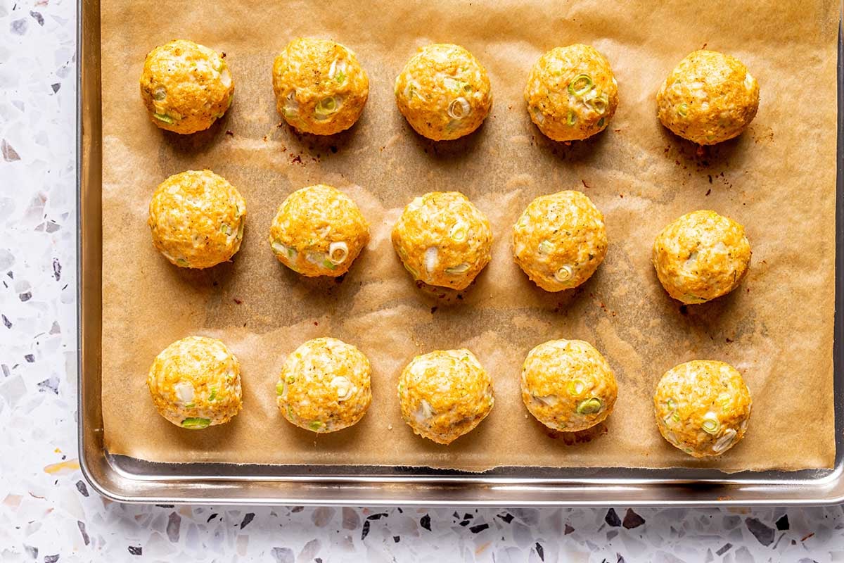 baked meatballs on a baking sheet.