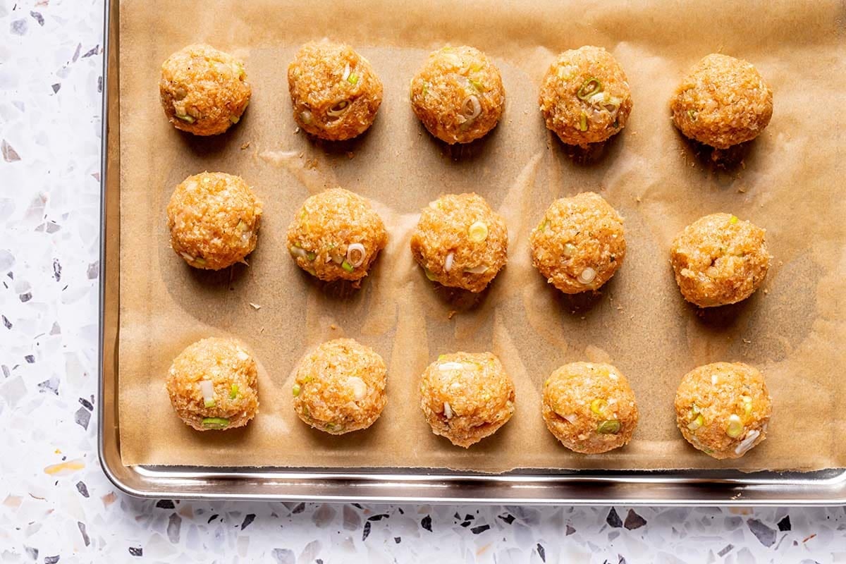 shaped meatballs on a baking sheet.