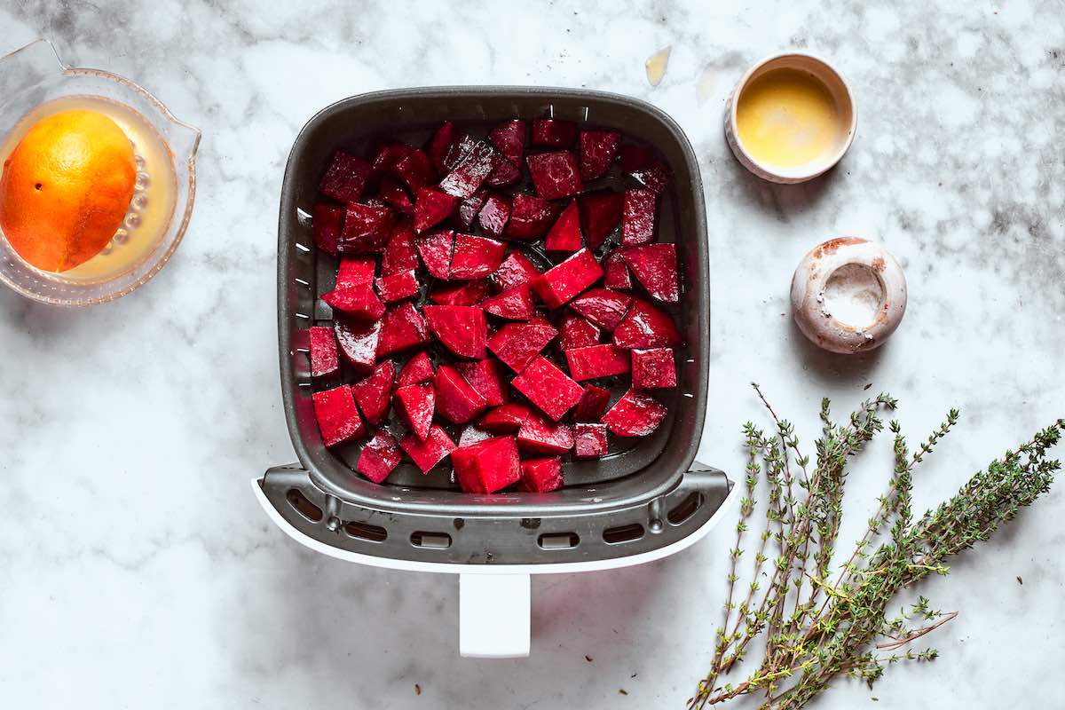 seasoned raw beets in air fryer basket.