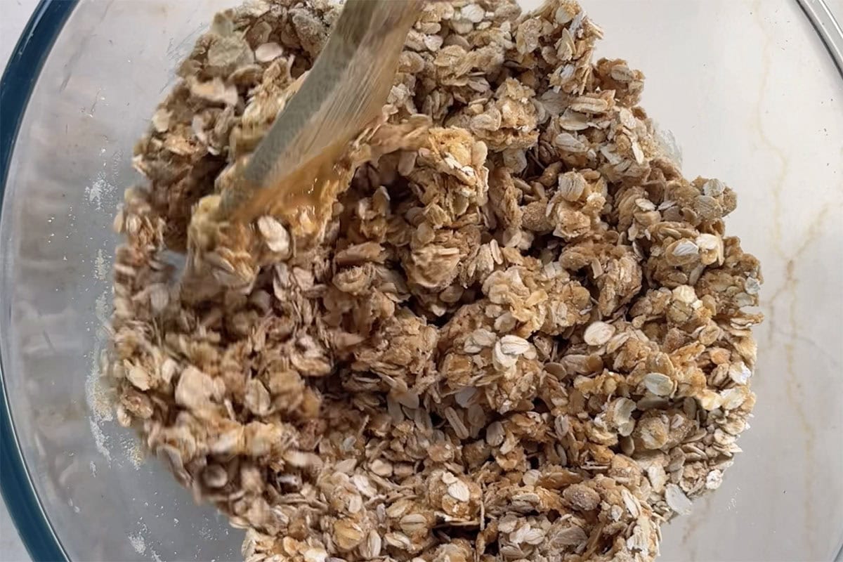 melted peanut butter and maple mixture coated over oats and peanuts.