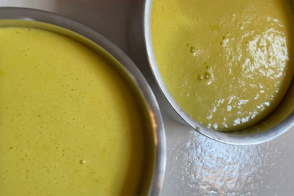 vegan lemon cake batter in two cake pans.