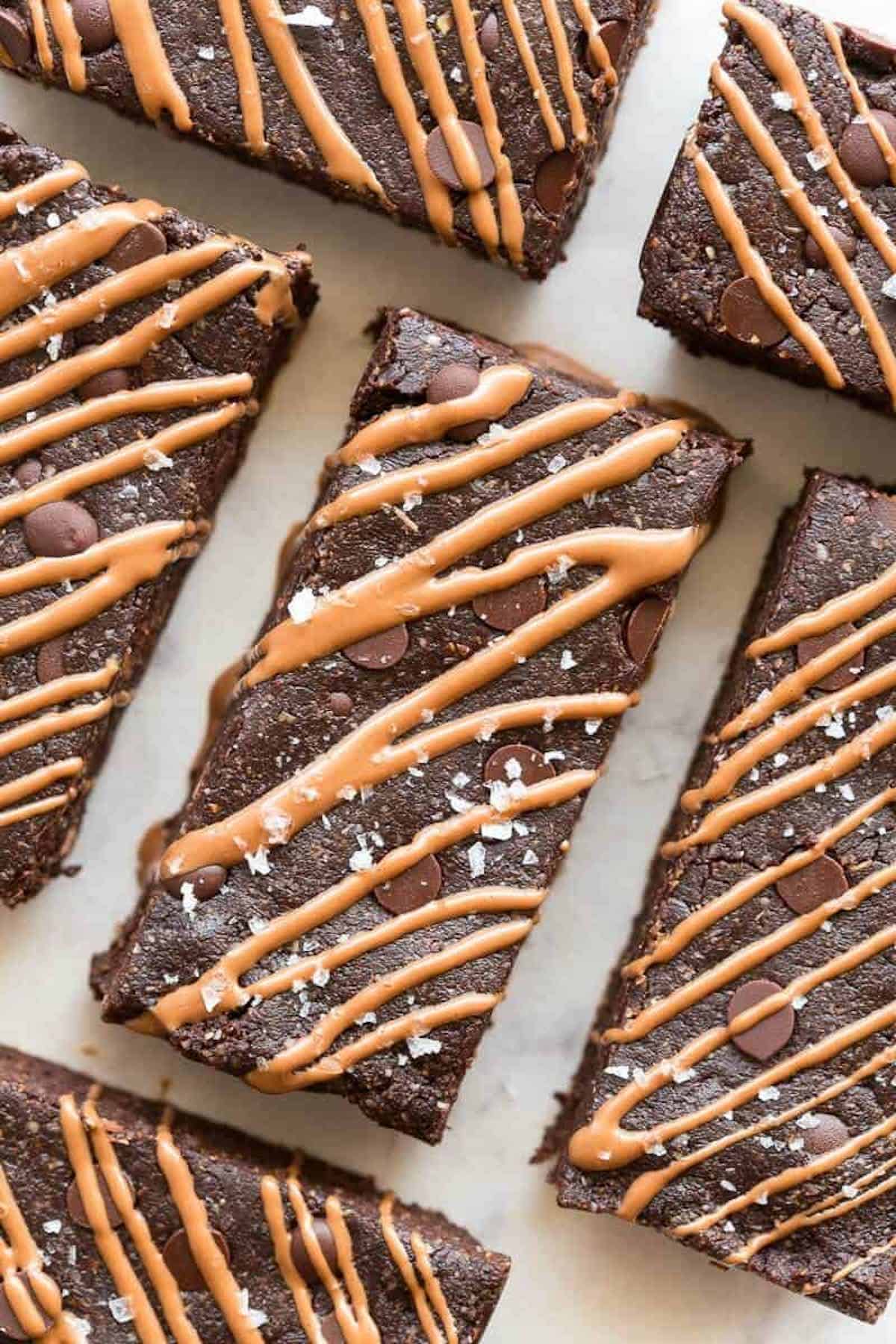 Sliced chocolate protein bars with chocolate chips and chocolate drizzle.