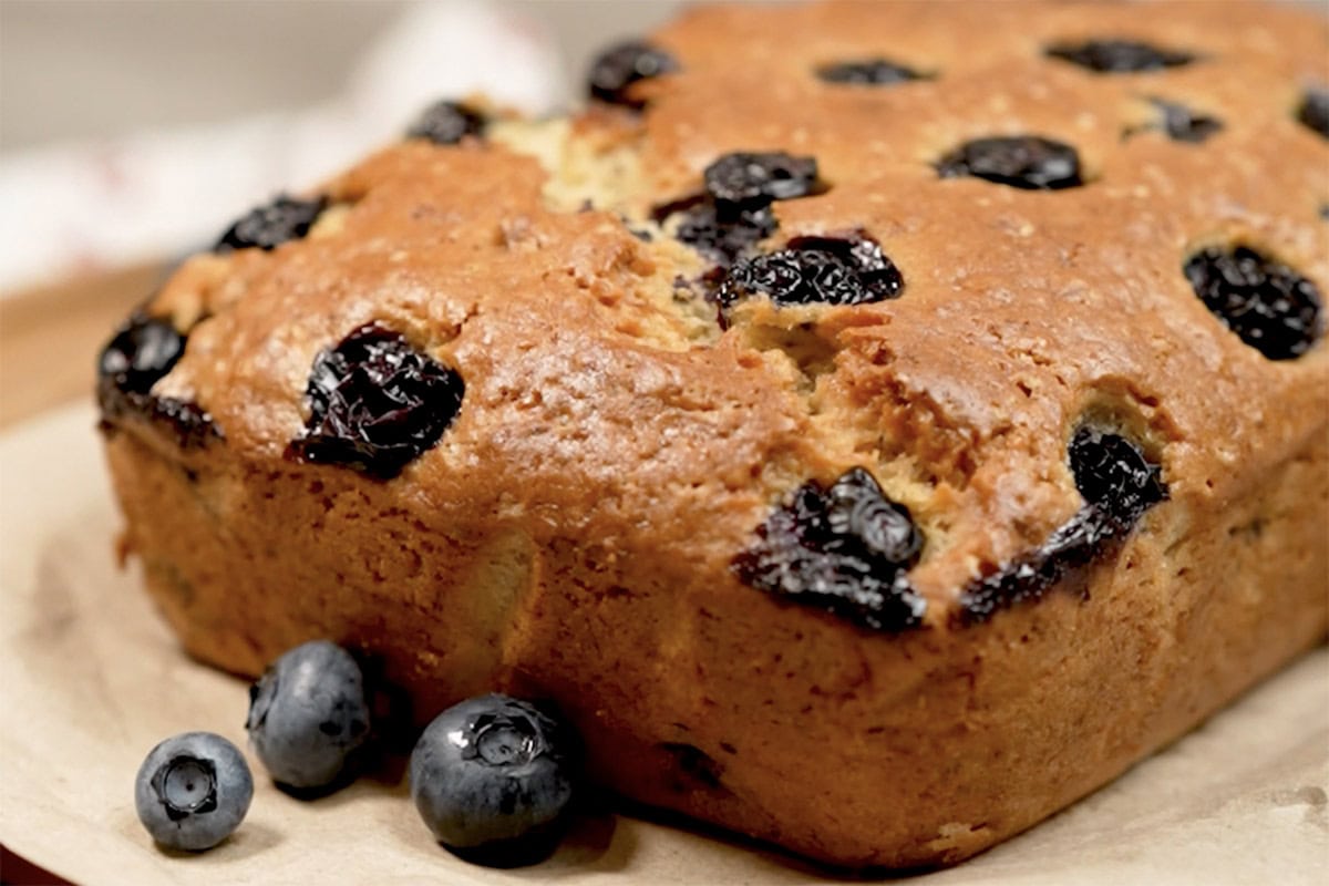 baked blueberry banana bread on parchment paper.