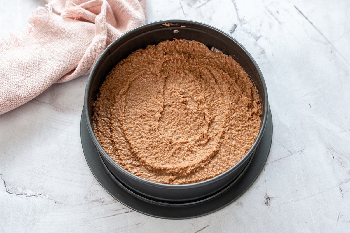 coconut flour chocolate cake batter in a cake greased black cake tin.