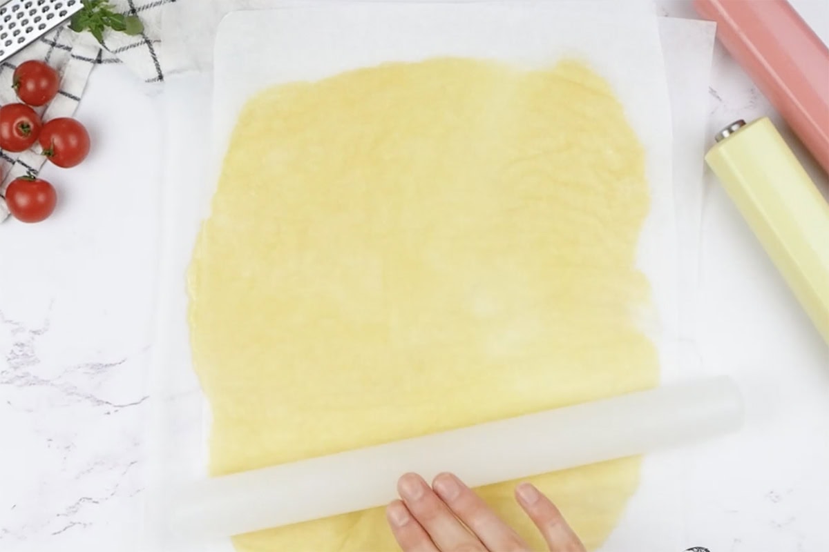 rolling out egg yolk and mozzarella mixture.