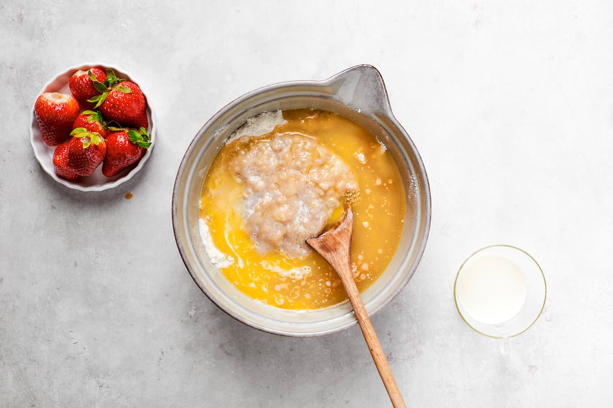 melted butter, mashed bananas, and flour in a bowl.