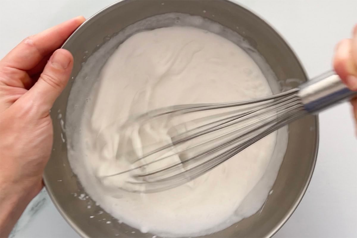whipping cream in a mixing bowl.