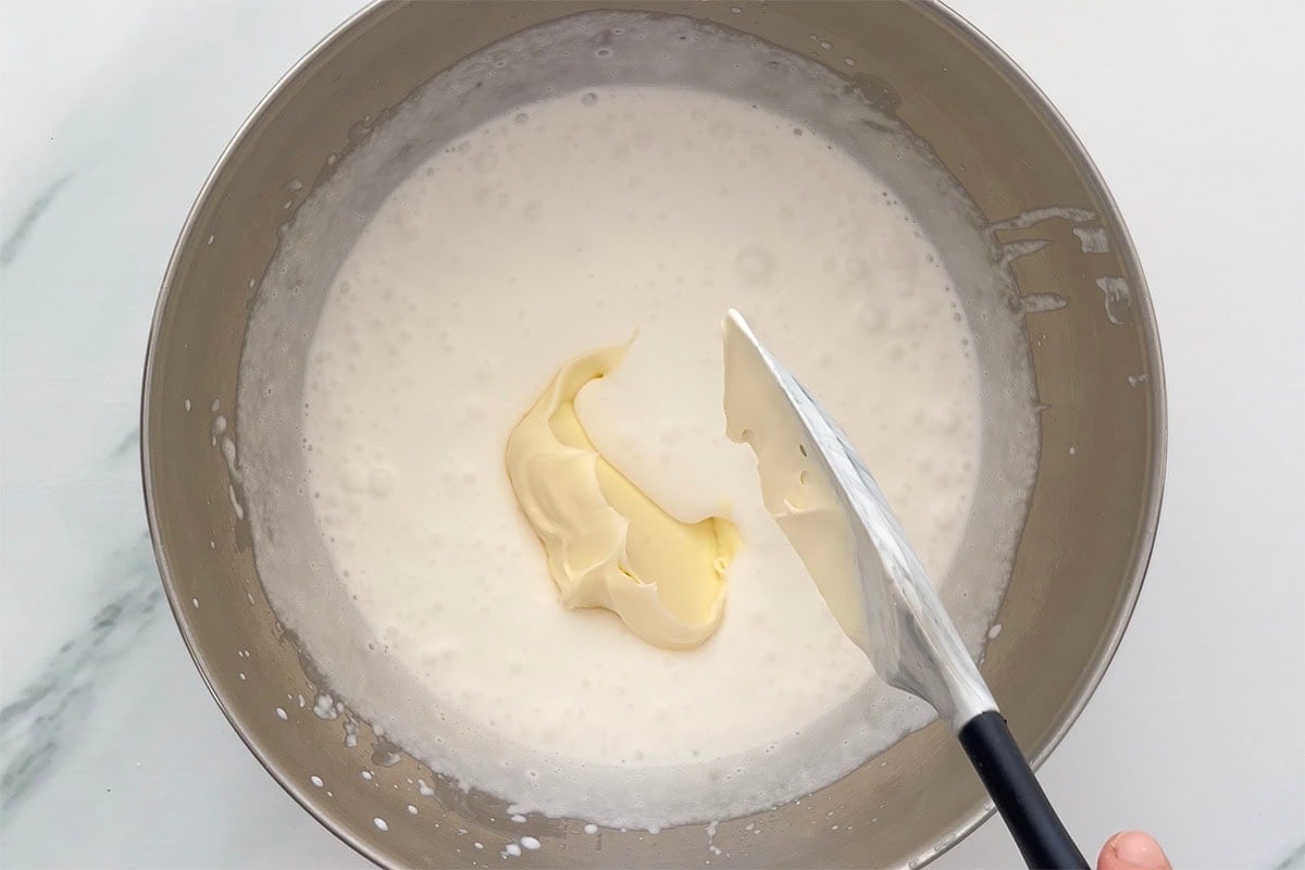 folding in whipped coconut milk into heavy cream mixture.