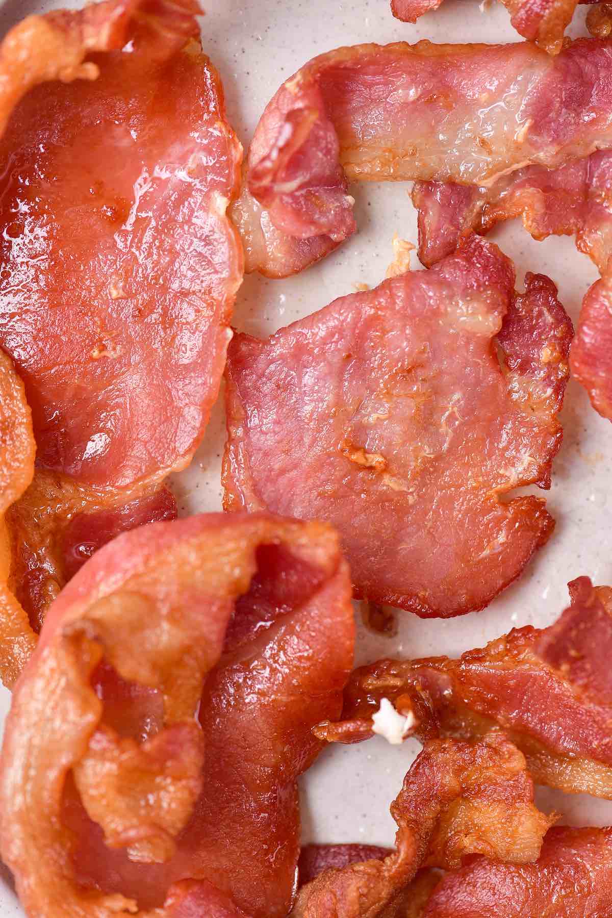 air fryer bacon on a white plate.