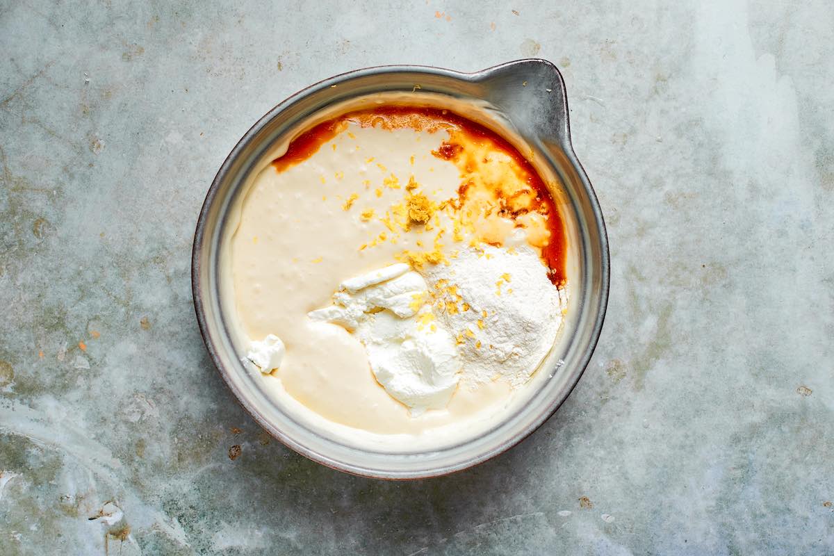 cream cheese, sugar, sour cream, vanilla, lemon zest, and flour in a mixing bowl.