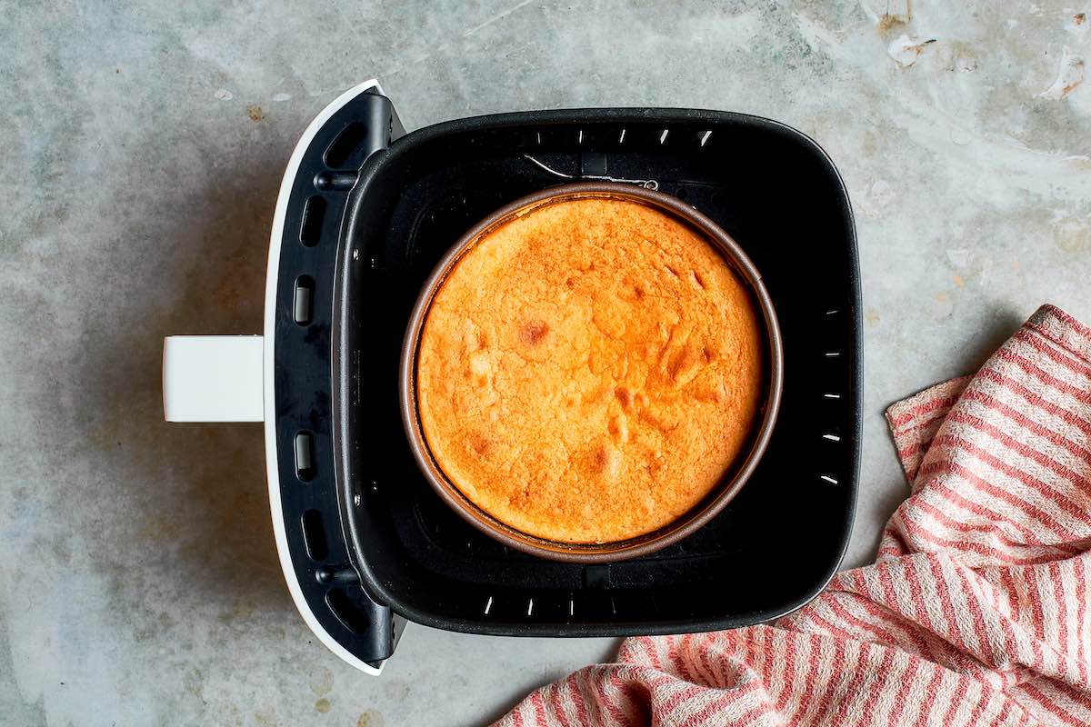 baked air fryer cheesecake in the air fryer basket.
