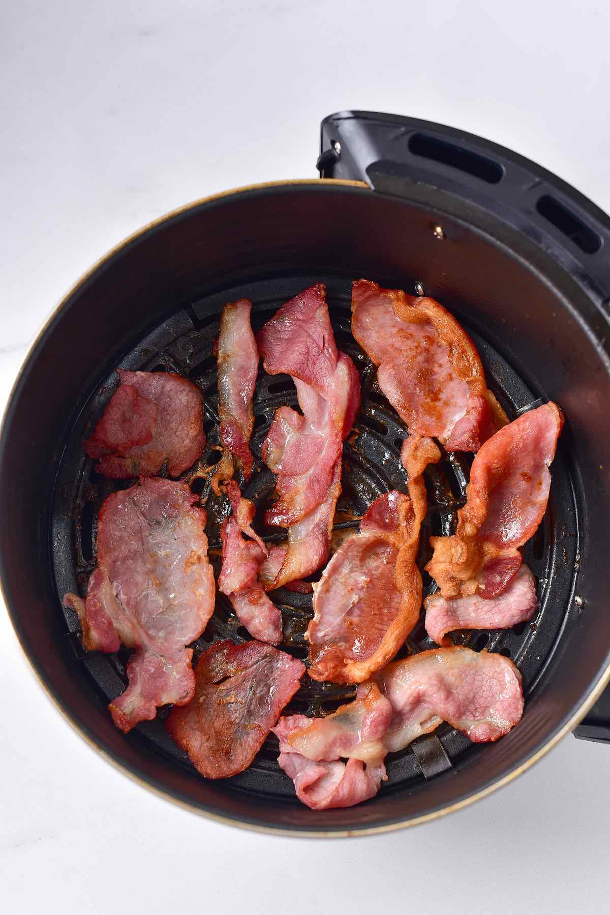 crispy bacon in the air fryer basket.