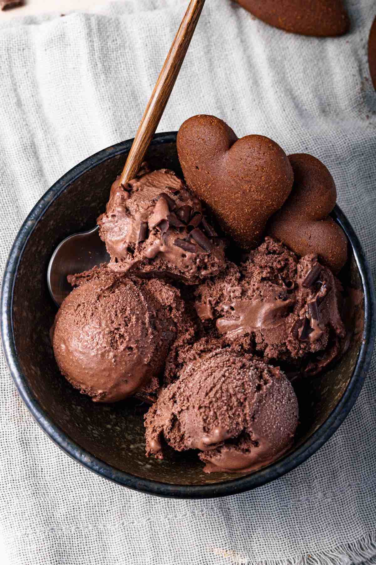 four scoops of brownie ice cream in a bowl, overhead shot.