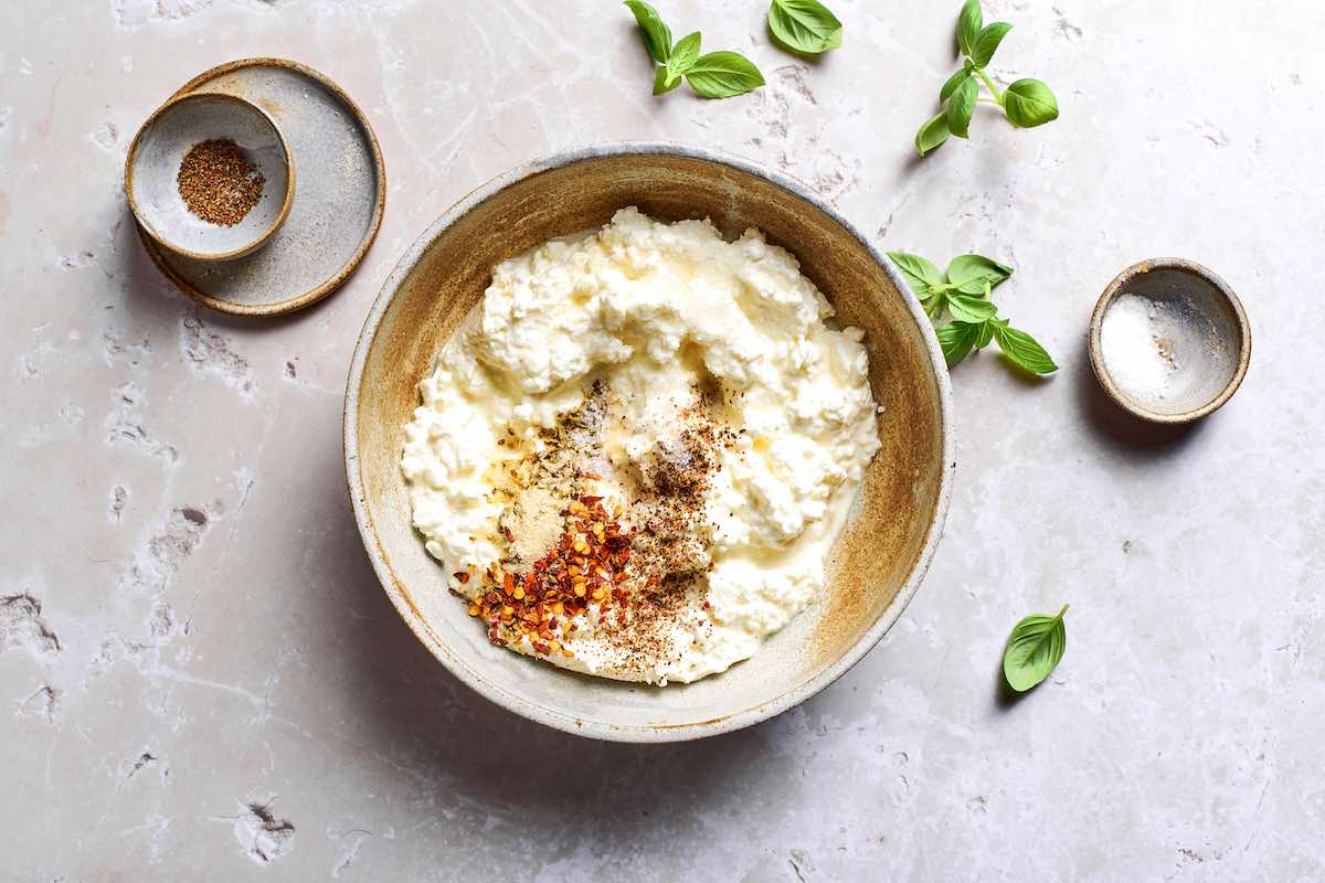 cottage cheese, salt, pepper, basil, and red pepper flakes in a bowl.