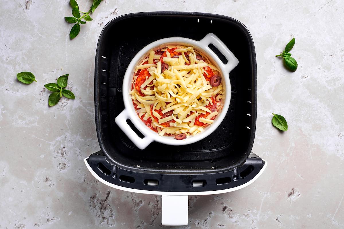 assembled cottage cheese bowls in the air fryer basket.