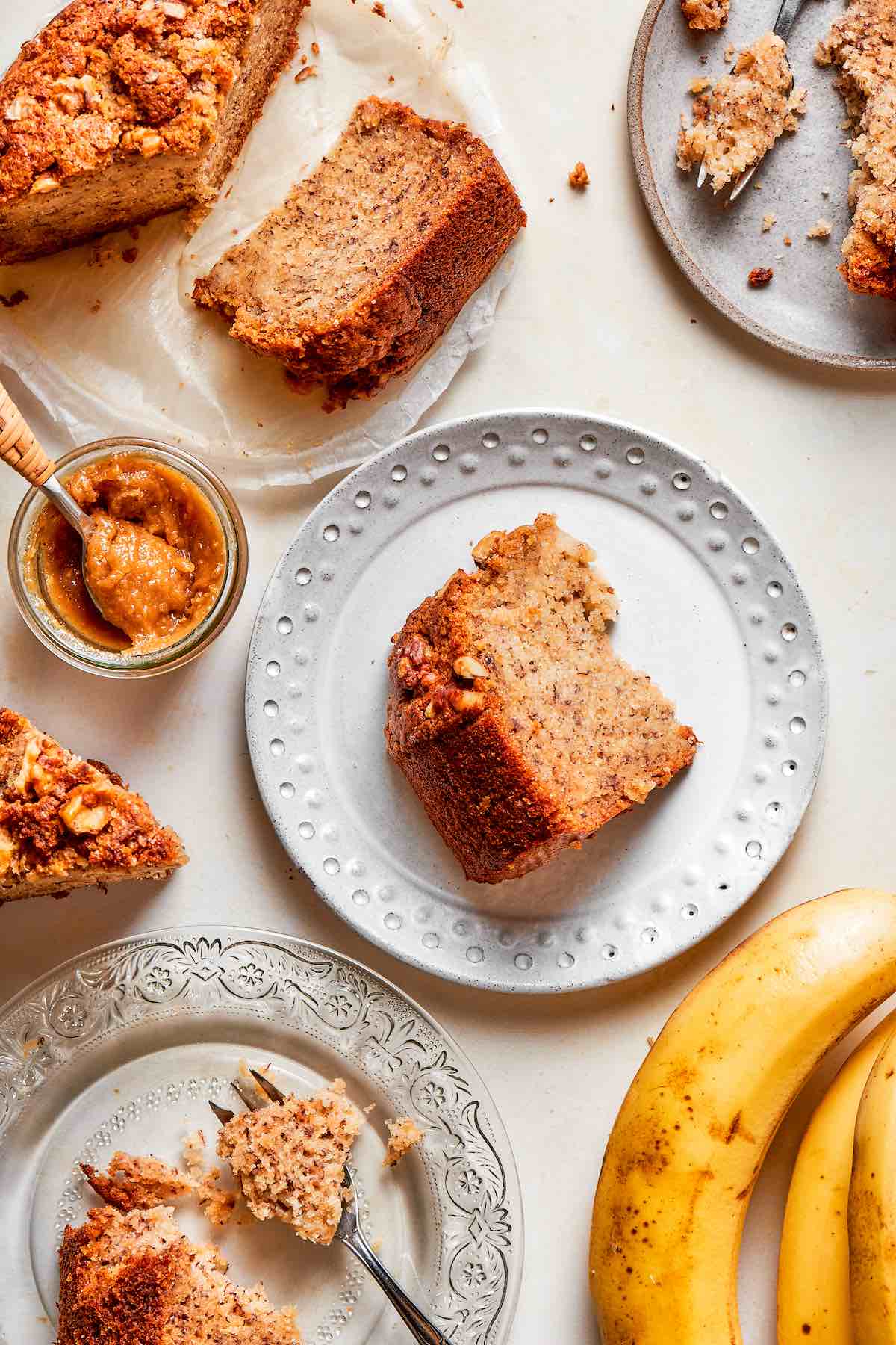 slices of air fryer banana bread on white plates.