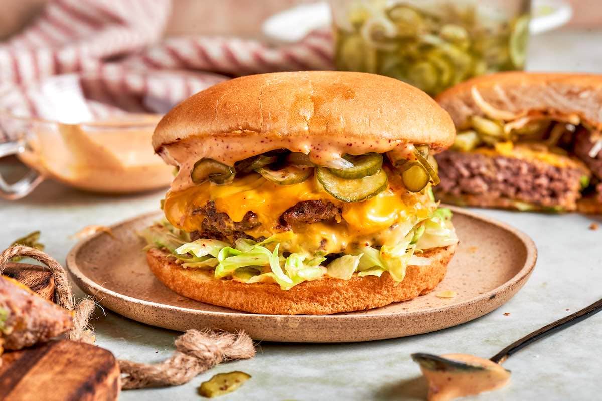 assembled air fryer smash burgers on a plate.