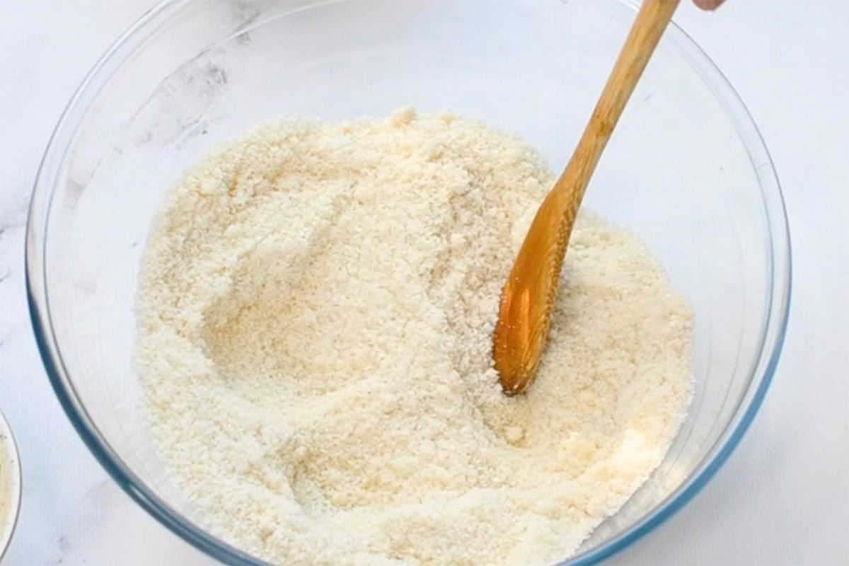 almond flour and white sugar mixed together in a glass bowl.