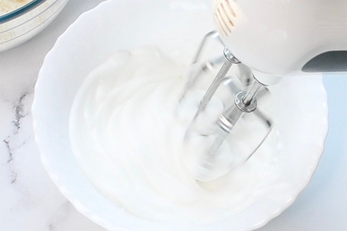 egg whites beaten to stiff peaks in a bowl.