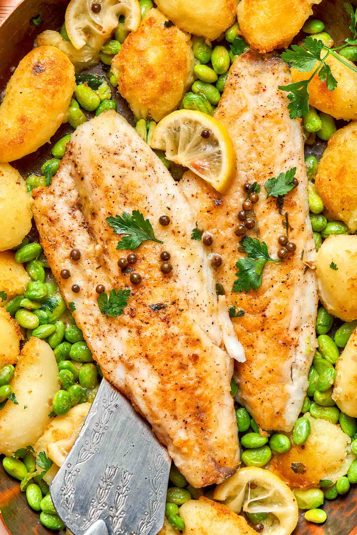 pan seared walleye fillets over edamame, potatoes, and fresh lemons.