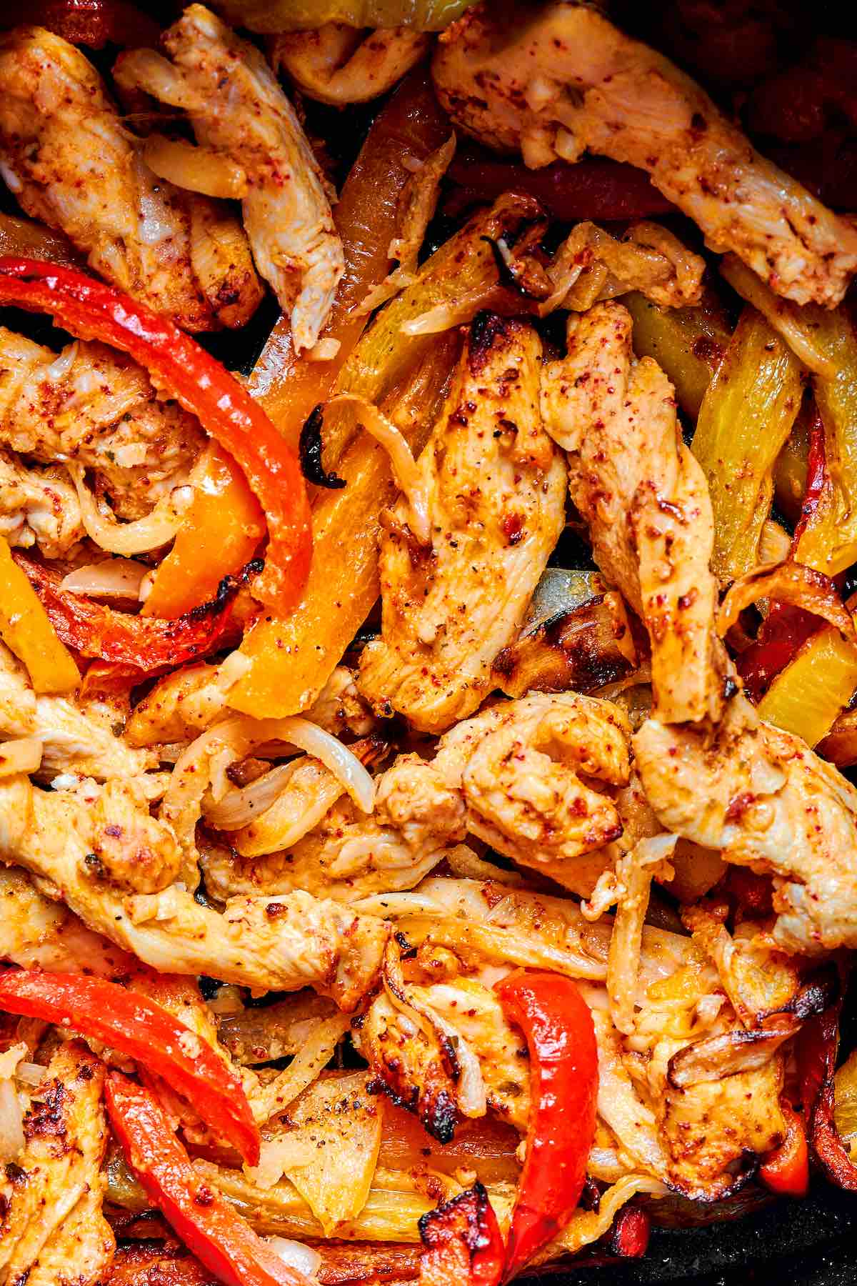 air fryer chicken fajitas in the air fryer basket.