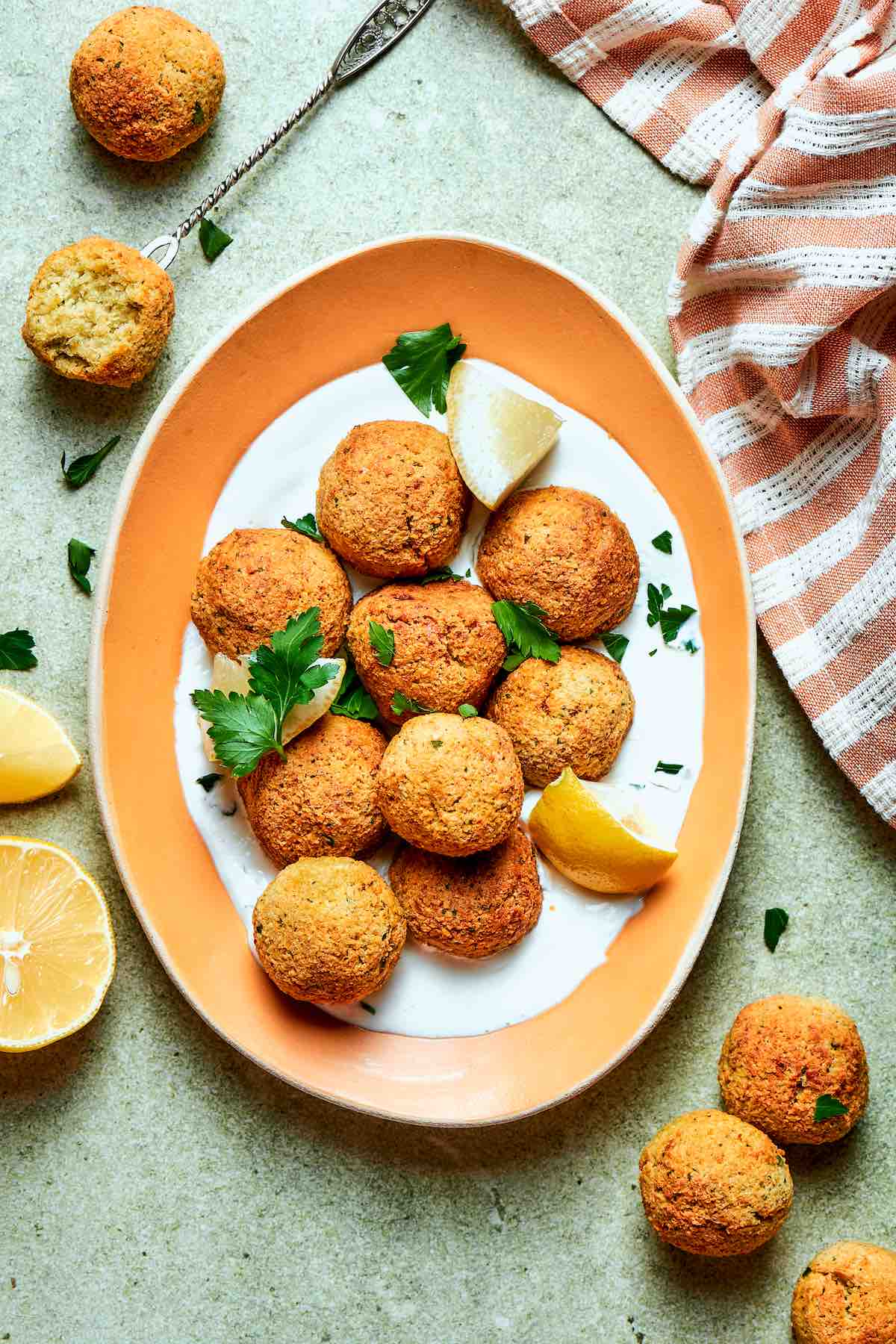 air fryer falafel over whipped yogurt and fresh herbs.