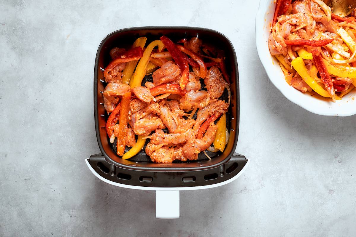 raw chicken fajita mixture in the air fryer.