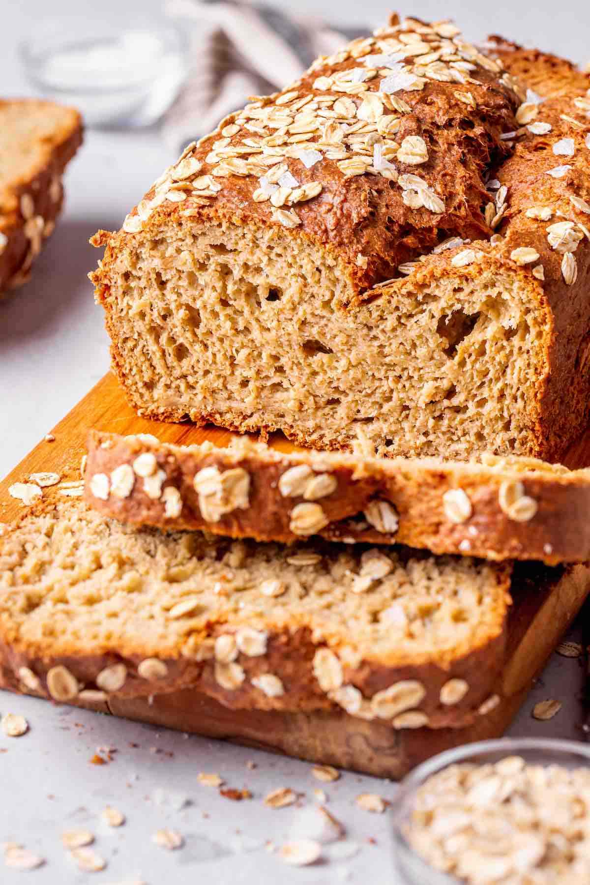 oat bread recipe, sliced on a wooden board.