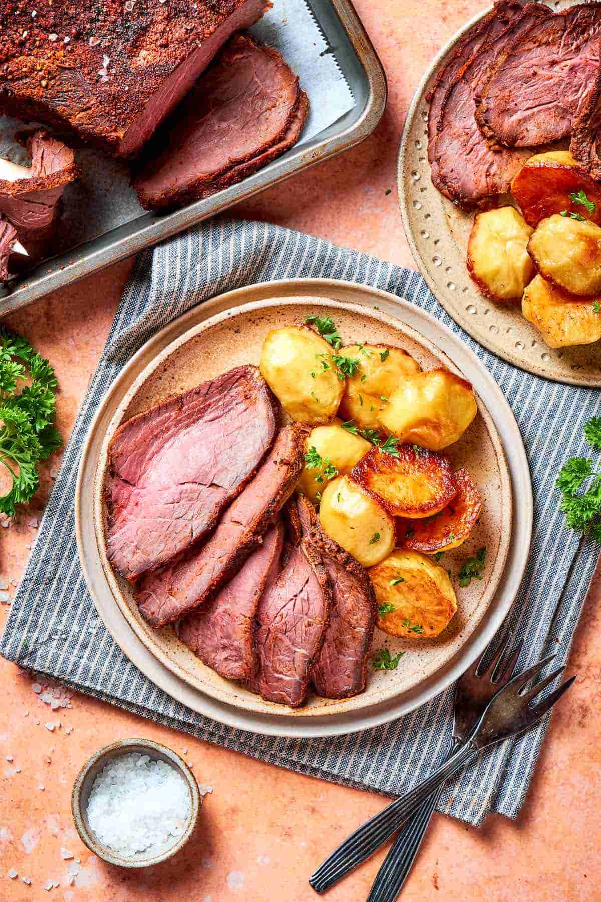 sliced tri tip roast with potatoes on a plate.